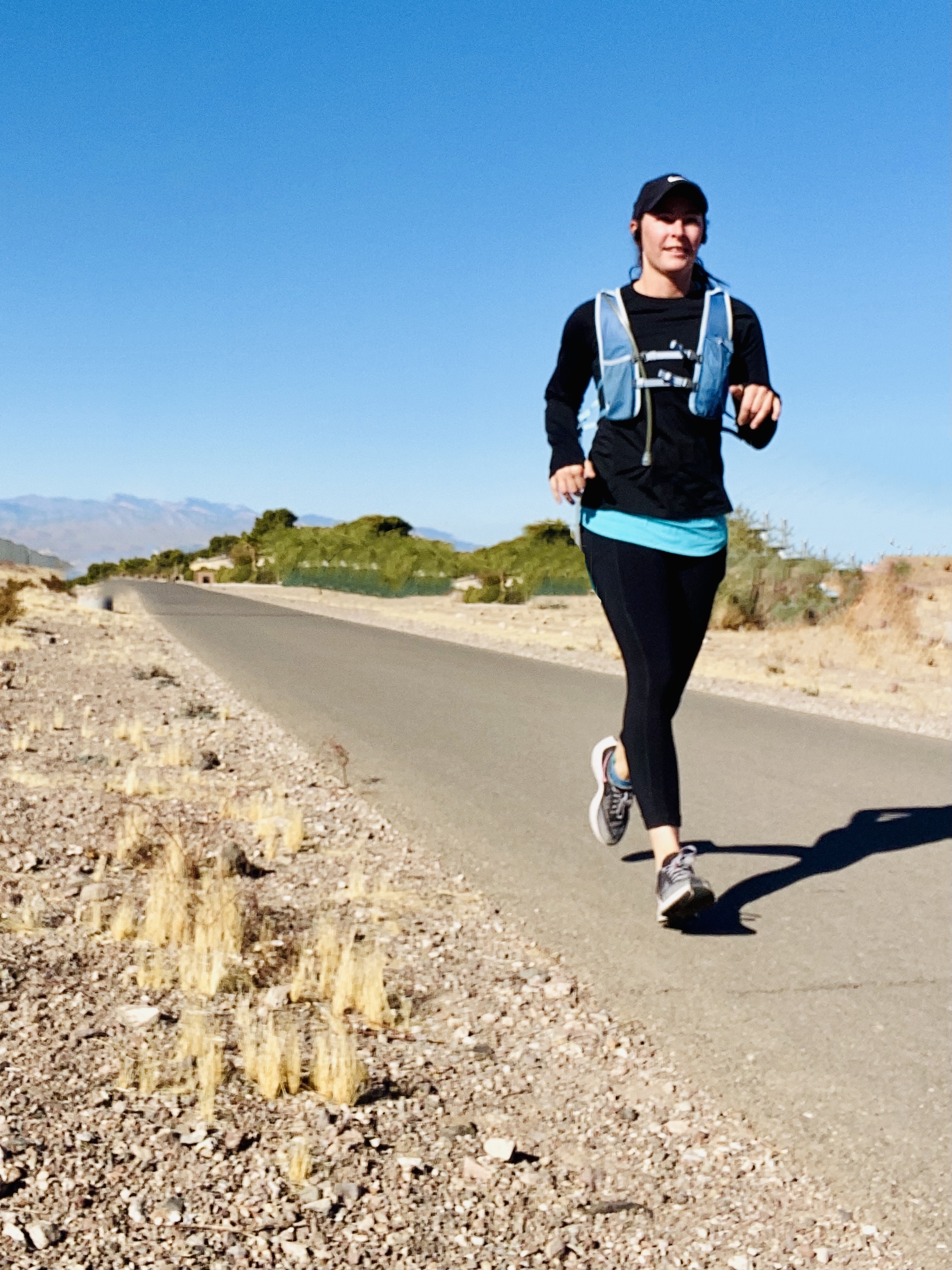 female runner on a desert road